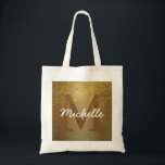 Bolsa Tote Saco Monograma Personalizado, Largura Dourada Faux<br><div class="desc">O fundo rico de ouro aplicado com uma falso brilho dourado cria uma vibração rica e quase antiga para este saco de tote. A inicial da mulher é marrom profundo para derreter no brilho do ouro. O brilho dourado cai sobre ele. O nome da mulher está em cima dele num...</div>
