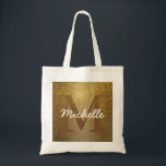 Bolsa Tote Saco Monograma Personalizado, Largura Dourada Faux<br><div class="desc">O fundo rico de ouro aplicado com uma falso brilho dourado cria uma vibração rica e quase antiga para este saco de tote. A inicial da mulher é marrom profundo para derreter no brilho do ouro. O brilho dourado cai sobre ele. O nome da mulher está em cima dele num...</div>