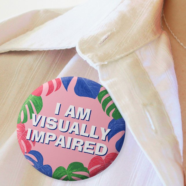 Bóton Redondo 2.54cm Folhas Tropicais Rosa Femininas Visualmente Impara (In Situ of badge with colorful leaves border and text "I am visually impaired")