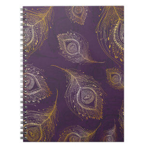 Caderno Espiral Dourada pena de pavão, fundo violeta.