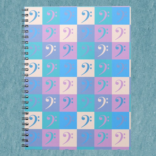 Caderno Espiral Padrão deClave de Fá Pastel (A notebook with a pattern of bass clef music symbols in blue, yellow, pink and purple.)