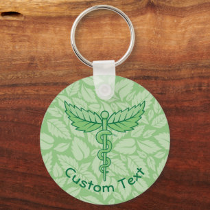 Caduceus com Chaveiro de Fundo de Folhas