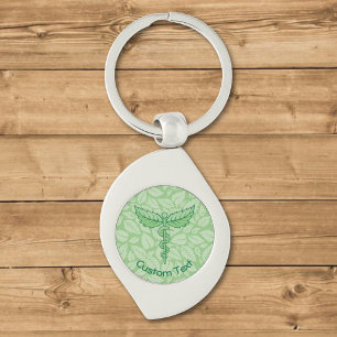 Caduceus com Chaveiro de Fundo de Folhas