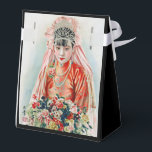 Caixinha De Lembrancinhas Noiva de Vermelho no Casamento Chinês em Xangai<br><div class="desc">O ar bateu com a alegre antecipação de um dia de casamento. A jovem, Xiaohua, ficou banhada no brilho quente da sala, uma visão de elegância juvenil. Seu rosto, sem falhas com um toque de maquiagem leve que enfatizava suas características juvenis, foi enquadrado por uma cascata de cabelos pretos adornada...</div>