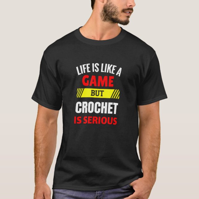 Camiseta A vida é como um jogo, mas Crochet é muito diverti (Frente)