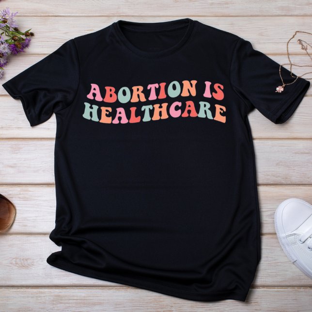 Camiseta Aborto é assistência médica (Criador carregado)