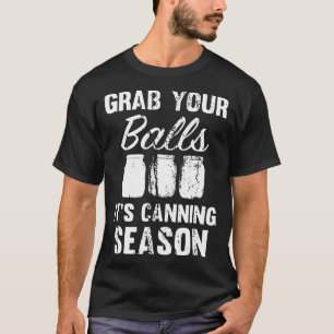 Camiseta agarre suas bolas que está enlatando os frascos d