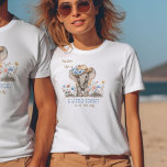 Camiseta Anúncio de bebê do pequeno cowboy Boho Elephant<br><div class="desc">Camisa fofa com elefante bebê em um chapéu de vaqueiro e muitas flores silvestres. A tenda está escrita com "Saddle Up! Um pequeno vaqueiro está a caminho" na tipografia estilo ocidental e numa paleta de cores azul e castanho macia. Por favor, navegue na minha coleção de Chás de fraldas Boho...</div>