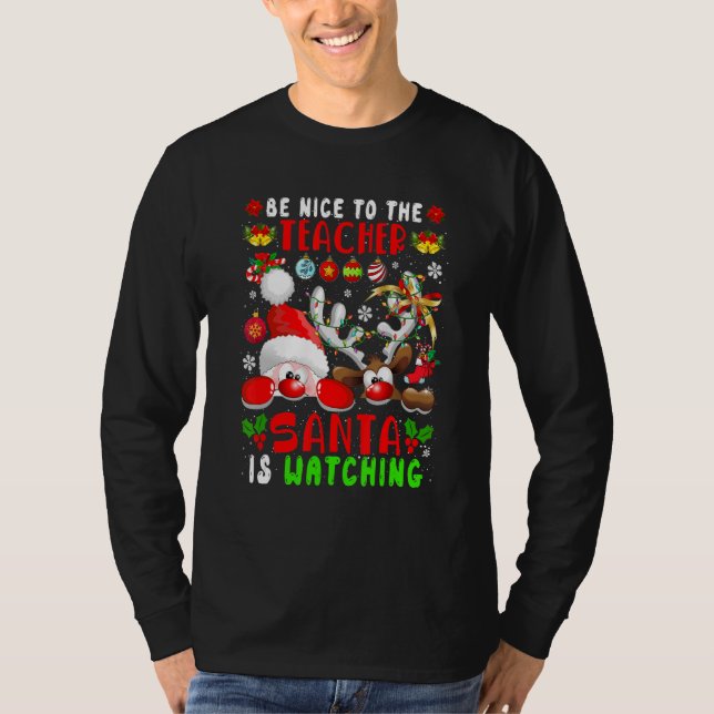 Camiseta Be Nice To The Teacher Santa Is Watching Xmas Sant (Frente)