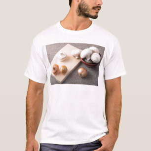 Camiseta Cogumelos e cebolas crus do cogumelo na mesa