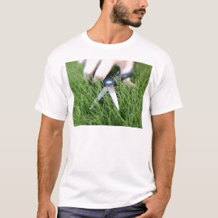 Camiseta Cortando a grama com um par de tesouras