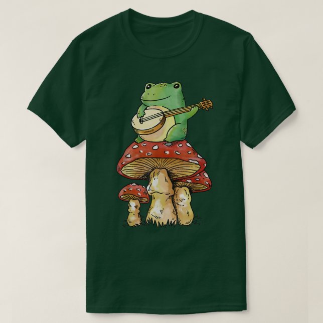 Camiseta cottagecore sapo de moagem de fada sobre cogumelos (Frente do Design)