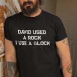 Camiseta David usou uma pedra que eu uso uma glock<br><div class="desc">Este design pode ser personalizado na área fornecida pela alteração da foto e/ou do texto. Ou pode ser personalizado clicando em Personalizar este Modelo e, em seguida, escolhendo o clique para personalizar mais a opção e excluir ou alterar a cor do plano de fundo, adicionar texto, alterar a cor ou...</div>