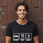 Camiseta Dormir Coma e Golfe Engraçado<br><div class="desc">Dormir Comendo e Golfe Engraçado T-Shirt Golfe - Agora percebemos que encontrar o presente perfeito para um amante de golfe pode ser um pouco complicado. Não olhemos mais além enquanto descortinamos esta camisa hilária especialmente projetada para o fanático golfe. A Camiseta de Golfe do Sono Comendo com símbolos de sinalização...</div>