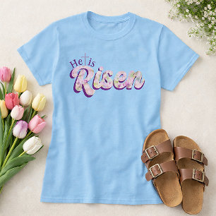 Camiseta Ele Ressuscitou Roxo Floral Script Páscoa Cristã