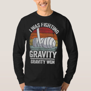 Camiseta Eu Estava Lutando Com Gravidade Ganhei Mão Quebrad