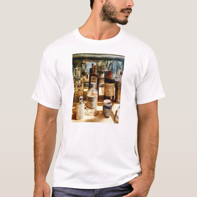 Camiseta Garrafa de Medicamento em Estojo de Vidro (Frente)