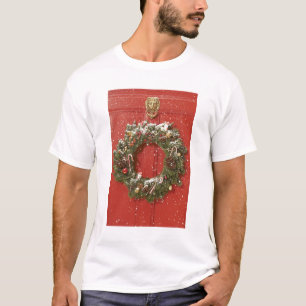 Camiseta Grinalda do Natal que pendura em uma porta