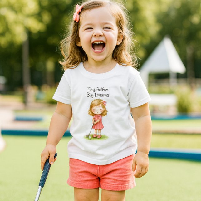 Camiseta Infantil Future Golfer Baby Girl or  ( joyful little golfer.  The lifestyle mockup captures her radiant laughter, playful energy,)