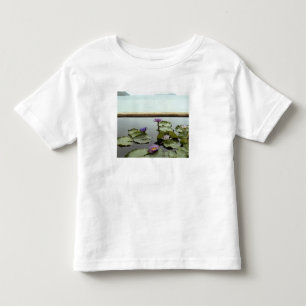 Camiseta Infantil Lírios de água na lagoa pelo oceano