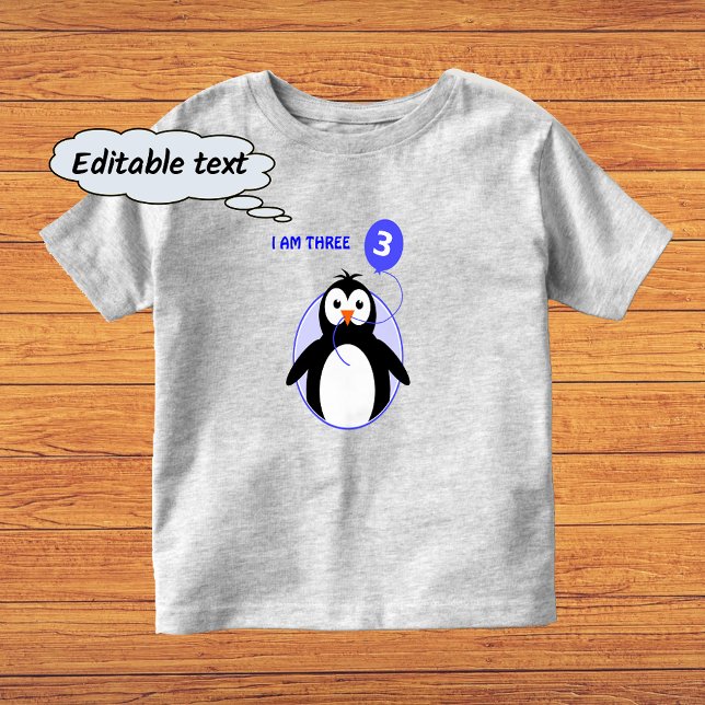 Camiseta Infantil Pinguim de aniversário texto personalizado azul de (Sample shows gray color t-shirt with 'vivid printing' option)
