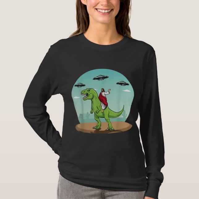 Camiseta Jesus Dirigindo Um Dinossauro Engraçado OVNI Alien (Frente)