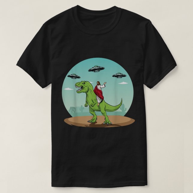 Camiseta Jesus Dirigindo Um Dinossauro Engraçado OVNI Alien (Frente do Design)