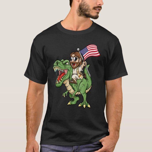 Camiseta Jesus Riding A Tyrannosaurus Rex Dinosaur USA Flag (Frente)