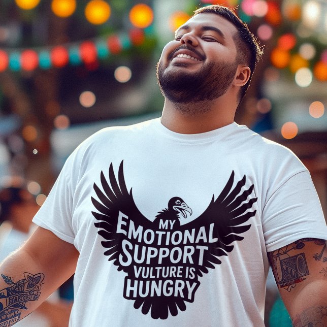Camiseta Neurodivergence Humor Emotional Support Vulture  (Young man wearing Emotional Support Vulture neurodivergent tee enjoying a street fair festival.)