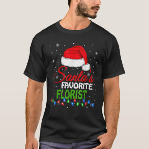 Camiseta Papais noeis favoritos de Florist Santa Hat acende