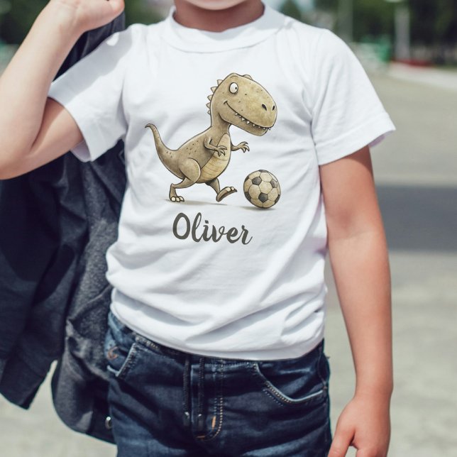 Camiseta Para Bebê Cute Tiny Trex Jogando Futebol (Criador carregado)