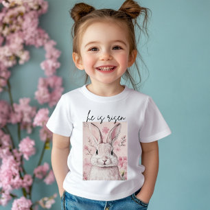 Camiseta Para Bebê "Ele Ressuscitou" Coelho Rosa com Flor