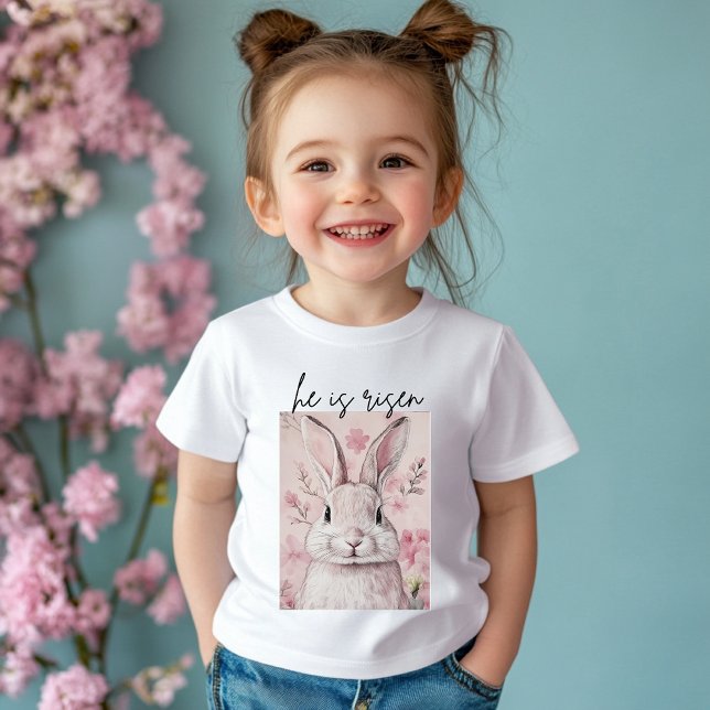 Camiseta Para Bebê "Ele Ressuscitou" Coelho Rosa com Flor (Criador carregado)