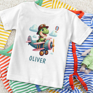 Camiseta Para Bebê T-Rex Dinossauro Fofo Voando um Avião Encantador