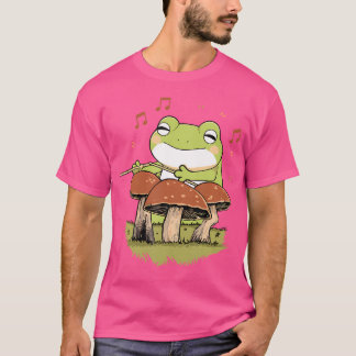 Camiseta Sapo De Cartoon Bonito Jogando No Cogumelo Do Tamb