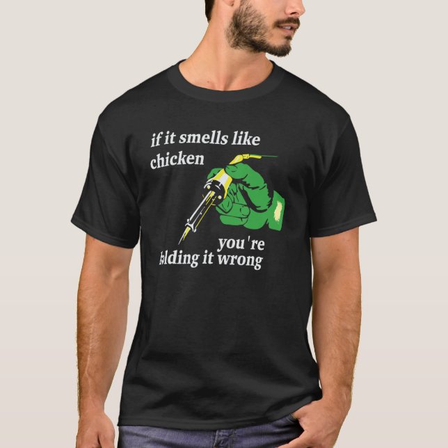 Camiseta Se cheira como frango, você está segurando errado (Frente)