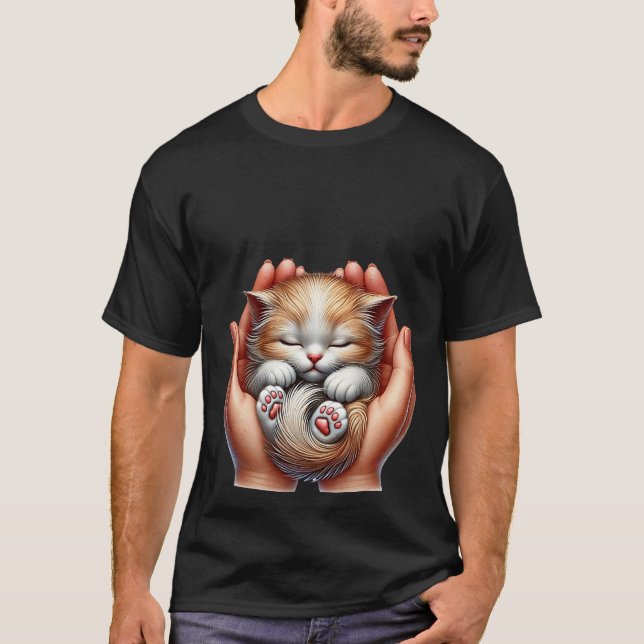 Camiseta Sleeping Kitten Cradled in Hands Tiny Fluffy Cat  (Frente)