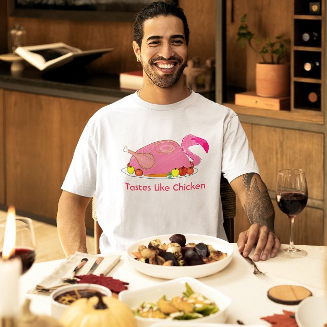 Camiseta Tem Gosto de Frango Funny Flamingo (male model at a holiday dinner wearing pink flamingo tastes like chicken funny t-shirt)