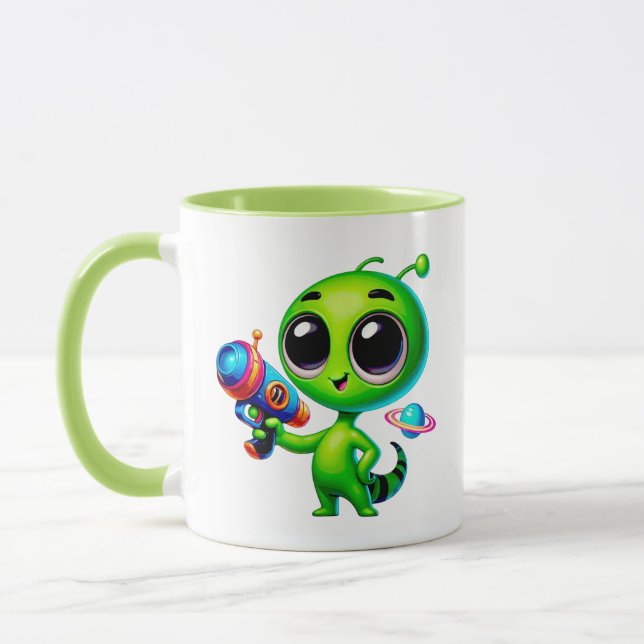 Caneca Alien mignon avec un pistolet laser et une planète (Esquerda)
