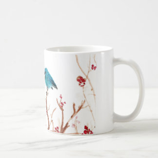 Caneca azul do pássaro e de café das bagas