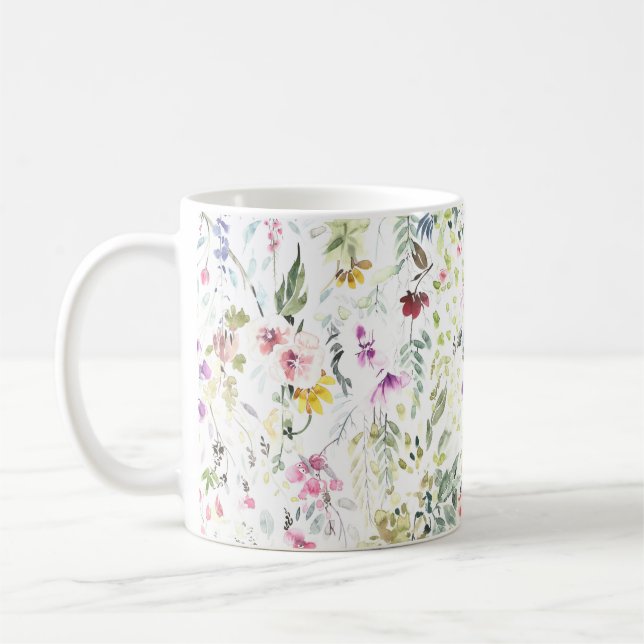 Caneca com a flor pintado mão e as plantas da (Esquerda)