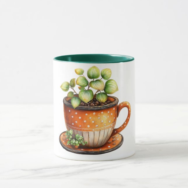 Caneca de café com xícara de café com planta dentr (Centro)