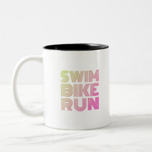 Caneca De Café Em Dois Tons Funcionamento da bicicleta da natação do Triathlon