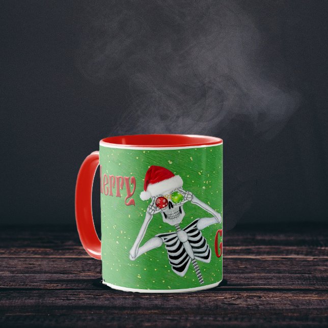 Caneca Feliz Bobo de Natal Skeleton Ornament Eyes Hat (Fun Skeleton Ornament eyes Red Merry Christmas text on Green with gold flecks coffee or tea mug.)
