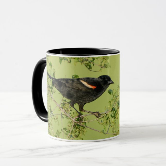 Caneca fundo verde de ave preto de asas vermelhas (Frente Esquerda)