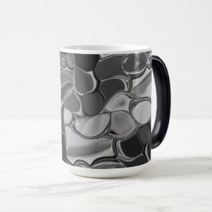 Caneca Mágica Cinzas claras e formas arredondadas escuras.