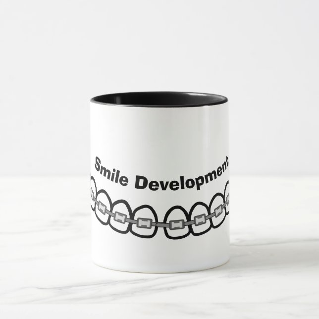Caneca O Desenvolvimento do Sorriso Traz Mug (Centro)