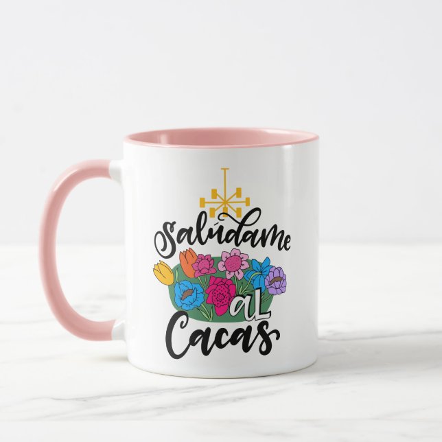 Caneca Saludame al Cacas, trabalho de arte desenhado à mã (Esquerda)