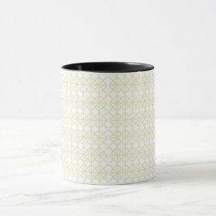 Caneca um padrão geométrico branco e dourado