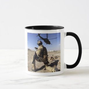 Caneca Um soldado conduz a segurança para um HH-60
